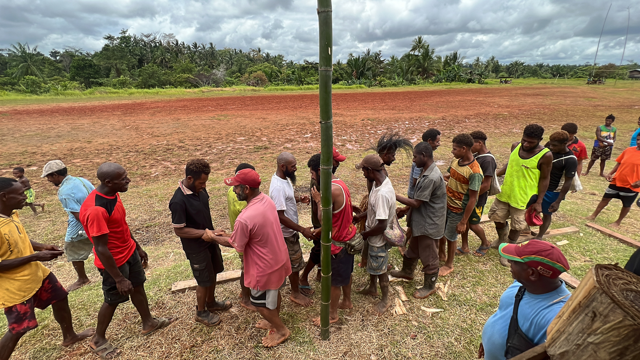 Mubami men reconcile moments after placing their faith in Christ, following days of fighting and drunkenness. The men forgiving one another and reconciling. Some others joined the procession in solidarity, so not all those pictured were involved in the events of the preceding days. All those who were involved repented and reconciled.